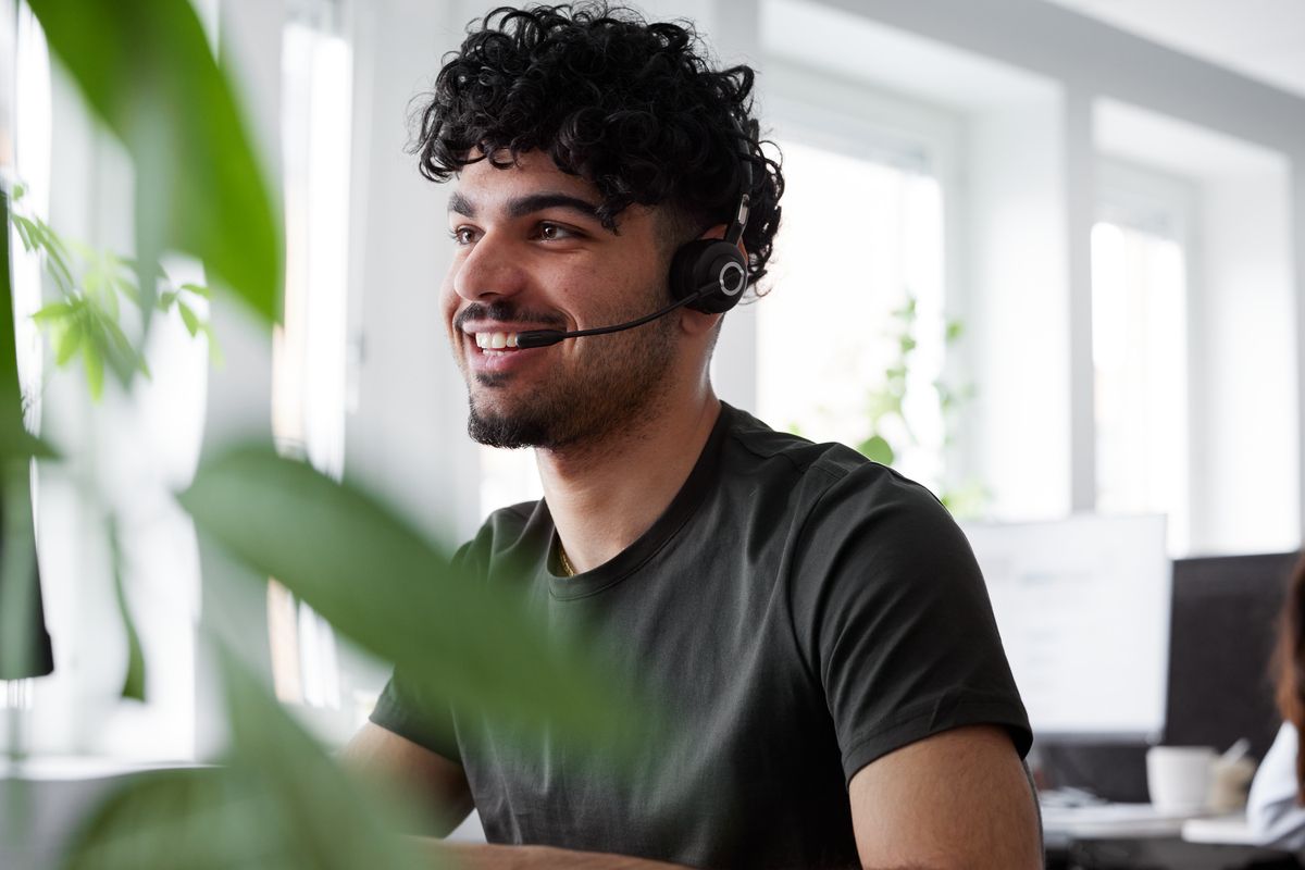 En kundebehandler med headset i en telefonsamtale